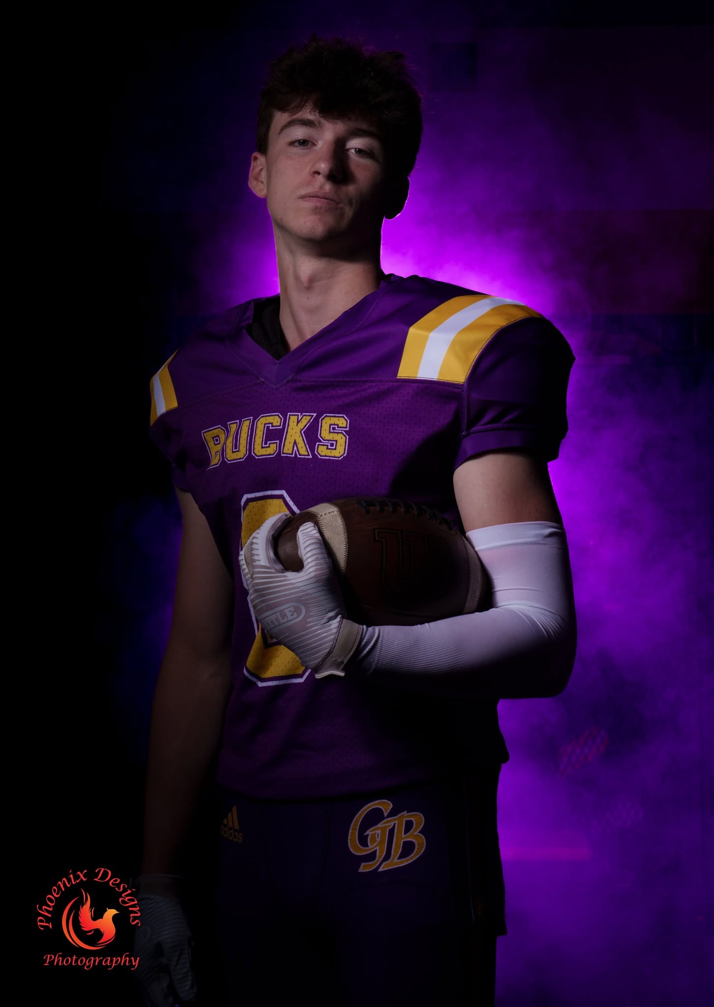 Football athlete in purple smoke